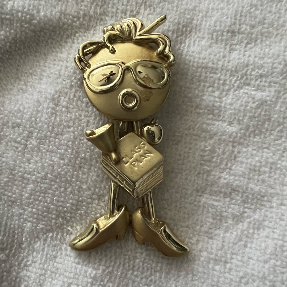 Gold teacher pin- head is moveable.